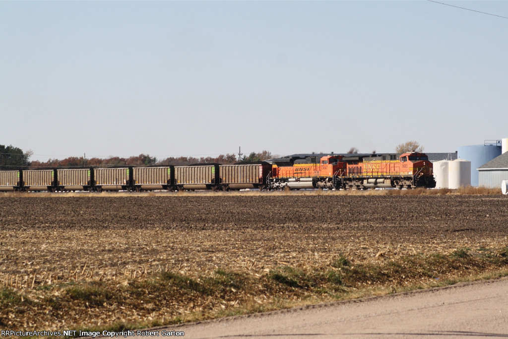 BNSF 5685 & 9067 bring a coal train through town
